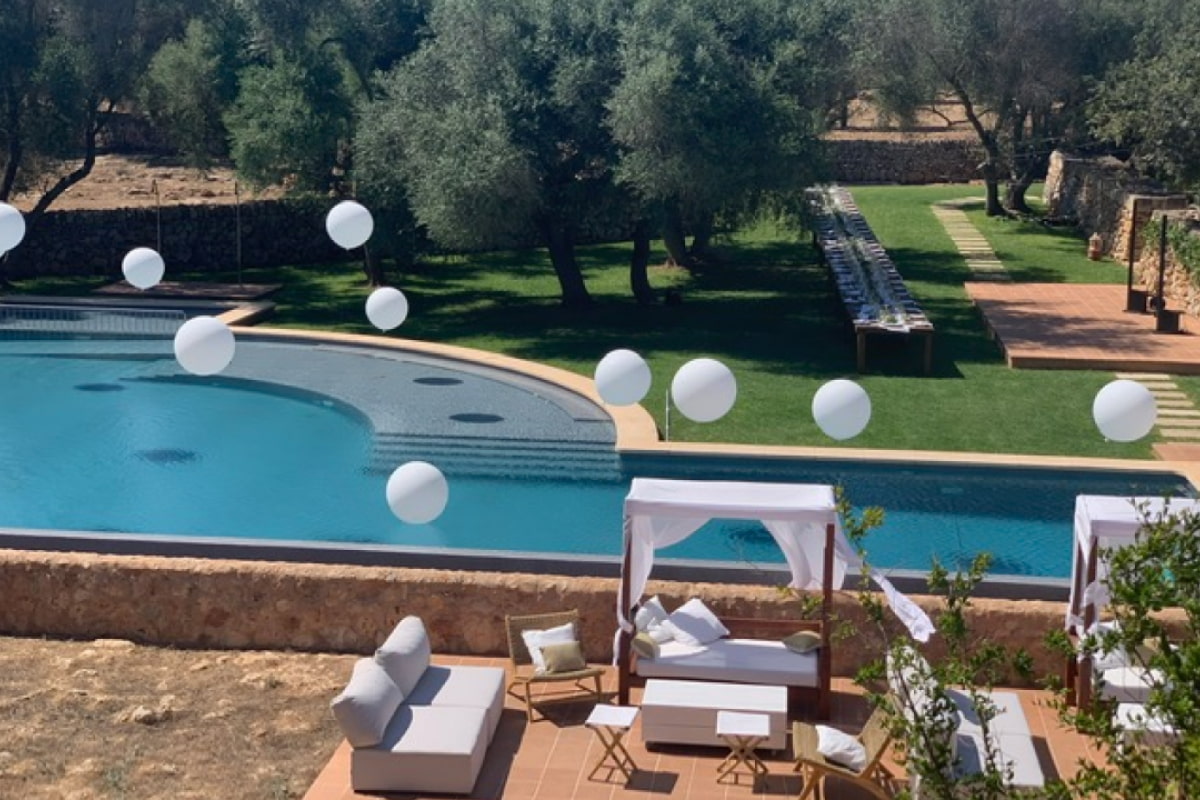 White balloons floating above the outdoor pool.