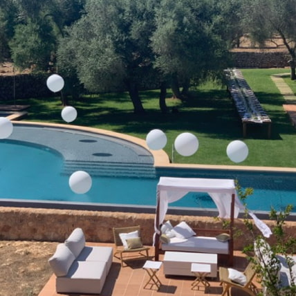 White balloons floating above the outdoor pool.