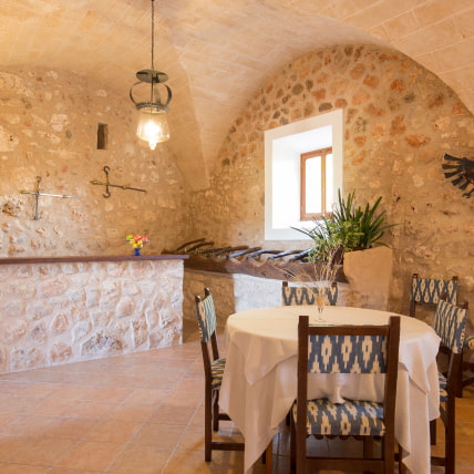 Interior dining room with vaulted ceilings and traditional Mallorcan decoration.