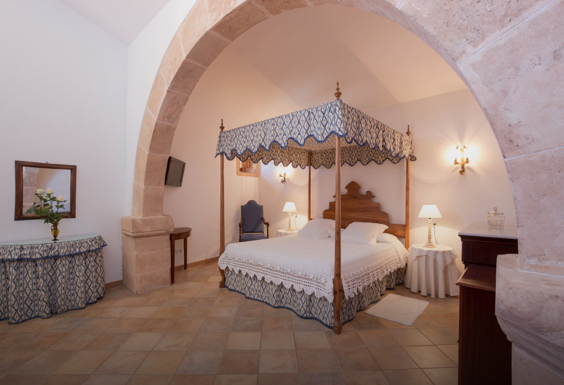 Doppelbett mit Himmel und typischen Stoffen der Insel